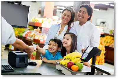 A happy family buying groceries.